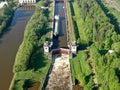 Flight over the river. Passage of hydraulic locks on the channel by commercial cargo ship.