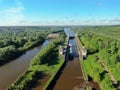 Flight over the river. Passage of hydraulic locks on the channel by commercial cargo ship