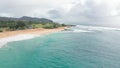 Flight over rocky coast of tropical island of Oahu Hawaii. View of Sandy Beach. Pacific Ocean Coastline. White clouds Royalty Free Stock Photo