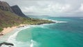 Flight over rocky coast of tropical island of Oahu Hawaii. View of Sandy Beach. Pacific Ocean Coastline. White clouds Royalty Free Stock Photo