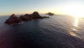 Flight over the sea and islands at sunset, Ajaccio area, Corsica, France. Aerial view.