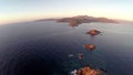 Flight over the sea and islands at sunset, Ajaccio area, Corsica, France. Aerial view.