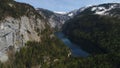 Flight over Toplitz lake in austrian Alps. Easiley snow-caped mountains and beautiful blue lake among them. Kammersee