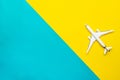 Flight plane travel concept. White toy airplane, aircraft on bright blue and yellow. Air sky fly background. Royalty Free Stock Photo