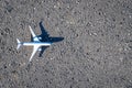 Flight plane white toy on dark asphalt background. Bright airplane, fly aircraft in air travel concept Royalty Free Stock Photo