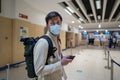 Flight rules during Covid-19 pandemic only in protective face mask. New normal concept. Masked man with phone in hand