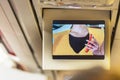 In-flight screen showing a female flight attendant making a safety briefing of how to use a life jacket in ecoonomy class Royalty Free Stock Photo