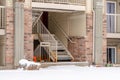 Flight of stairs at the residential building entrance with snowy yard in winter Royalty Free Stock Photo