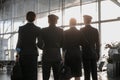 Flight team standing in the airport in front of the panoramic window Royalty Free Stock Photo
