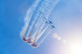 Flight team of three turboprop planes makes a loop in the sky lit by a bright sun