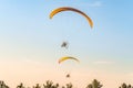 Flight of two motor paragliders trike skyward