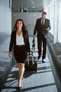 Flight, walking or business people in airport with suitcase, luggage or baggage for a global trip. Smile, happy woman or Royalty Free Stock Photo