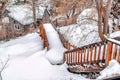 Flight of wooden stairs and hill slope covered with thick fresh snow in winter Royalty Free Stock Photo