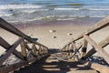 Flight of wooden steps leading down to a sandy beach Royalty Free Stock Photo