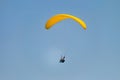 Flight on a yellow paraglider in blue sky