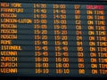 Flights information board in an international airport terminal Royalty Free Stock Photo