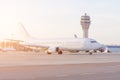 Flights management air control tower and passenger terminal in International airport with flying plane in clear sky, with split