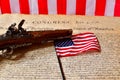 Flintlock pistol and American Flag on the Declaration of Independence