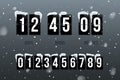 Flip countdown showing days, hours and minutes. Flip board with white numbers on black panels in retro style on snowfall