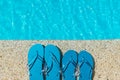 Flip Flop on stone Floor pool edge with surface of water background Royalty Free Stock Photo