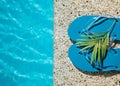 Flip Flop on Wood Floor pool edge with surface of water background Royalty Free Stock Photo