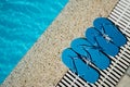 Flip Flop on Wood Floor pool edge with surface of water background Royalty Free Stock Photo