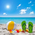 Flip flops and beach ball under a shining sun Royalty Free Stock Photo