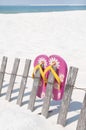 Flip flops on beach fence Royalty Free Stock Photo