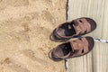 Flip-flops and beach litter on a sandy beach