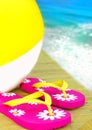 Flip Flops and Beachball by Ocean Royalty Free Stock Photo