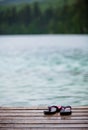 Flip flops on a Dock in front of a Turquoise Water Lake Royalty Free Stock Photo