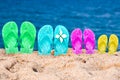 Flip flops of a family of four in the sand Royalty Free Stock Photo