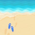 Flip flops and footsteps on the sand Royalty Free Stock Photo