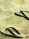 Flip flops lie in the sand