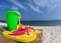 Flip flops and pail on boardwalk Royalty Free Stock Photo