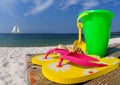 Flip flops and pail on boardwalk Royalty Free Stock Photo