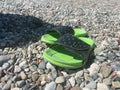 Flip-flops on a pebble beach background Royalty Free Stock Photo
