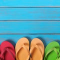 Flip flops in a row blue beach wood background summer border Royalty Free Stock Photo