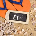 Flip-flops on the sand and word ete, summer in french Royalty Free Stock Photo