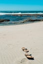 Flip flops on sandy beach Royalty Free Stock Photo