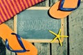 Flip-flops, starfish and chalkboard with the word summer Royalty Free Stock Photo