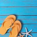 Flip flops starfish old bright blue beach wood square summer background Royalty Free Stock Photo