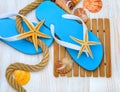 Flip-flops, starfish and seashells. Royalty Free Stock Photo