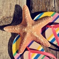 Flip-flops and starfish on a wooden pier Royalty Free Stock Photo