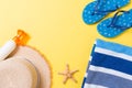 Flip flops, straw hat, starfish, sunscreen bottle, body lotion spray on yellow background top view . flat lay summer beach sea Royalty Free Stock Photo