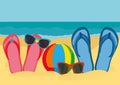 Flip-flops and sunglasses on the sandy shore of the ocean. Vector