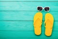 Flip flops, sunglasses. Summer accessories and copy space on blue wooden background. Top view Royalty Free Stock Photo