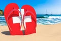 Flip flops with Swiss flag on the beach. Switzerland resorts, vacation, tours, travel packages concept. 3D rendering