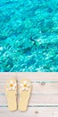 Flip flops with tiare flowers on the wooden planks decking above turquoise sea blurred background Royalty Free Stock Photo