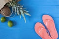Flip flops and tropical fruits on vivid blue wooden background. Summer concept. Flat lay, top view, copy space Royalty Free Stock Photo